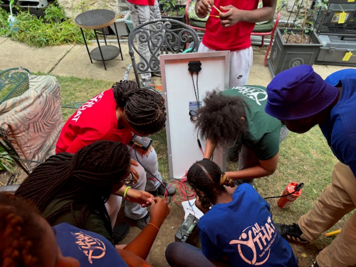 Youth working together on an electrical wiring project